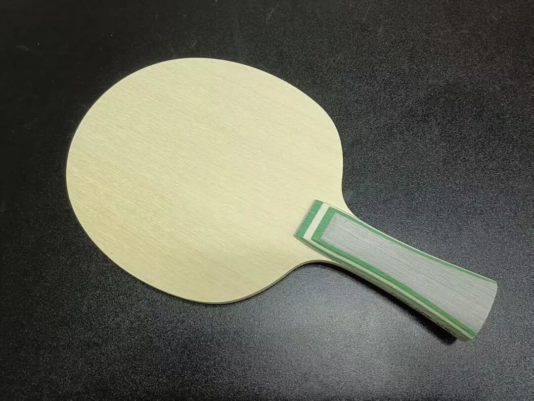 STIGA LUMA blade handle close-up showing green aramid carbon accent lines