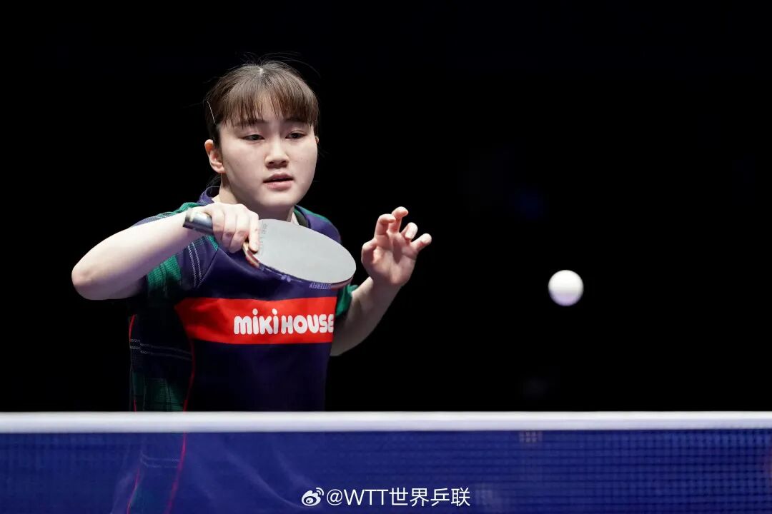 Daifuji Satsuki focused at the table during a WTT match, paddle raised for a forehand stroke