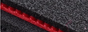 Joola black carbon sponge rubber cross-section showing dark dye coloring