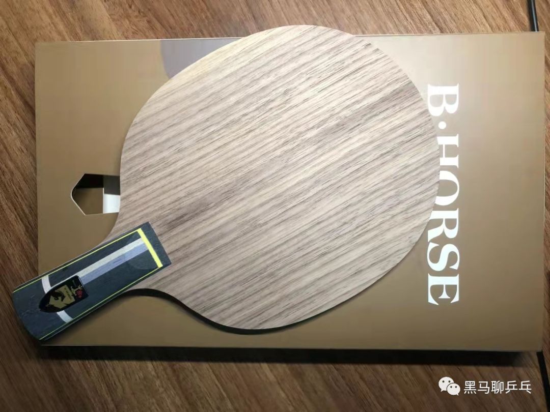 Stiga table tennis blade with distinctive layered handle resting on a table, showing the face and partial handle design