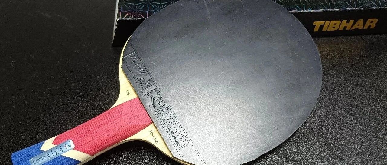 Tibhar blade fitted with K3 rubber, resting beside its box on a dark surface