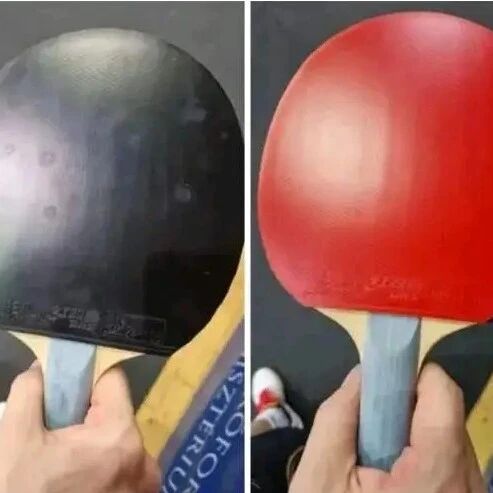Table tennis player holding a paddle with black and red rubber sheets, ready to serve
