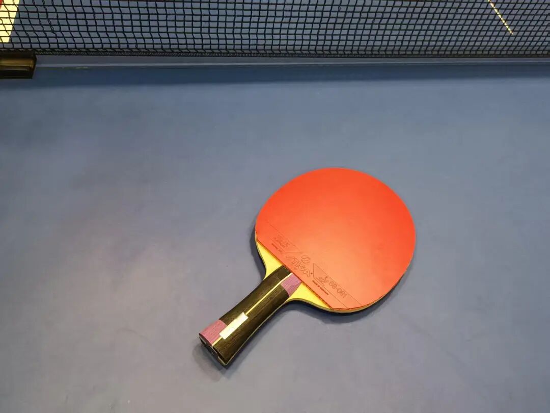Player sidestepping to forehand attack position during table tennis match rally