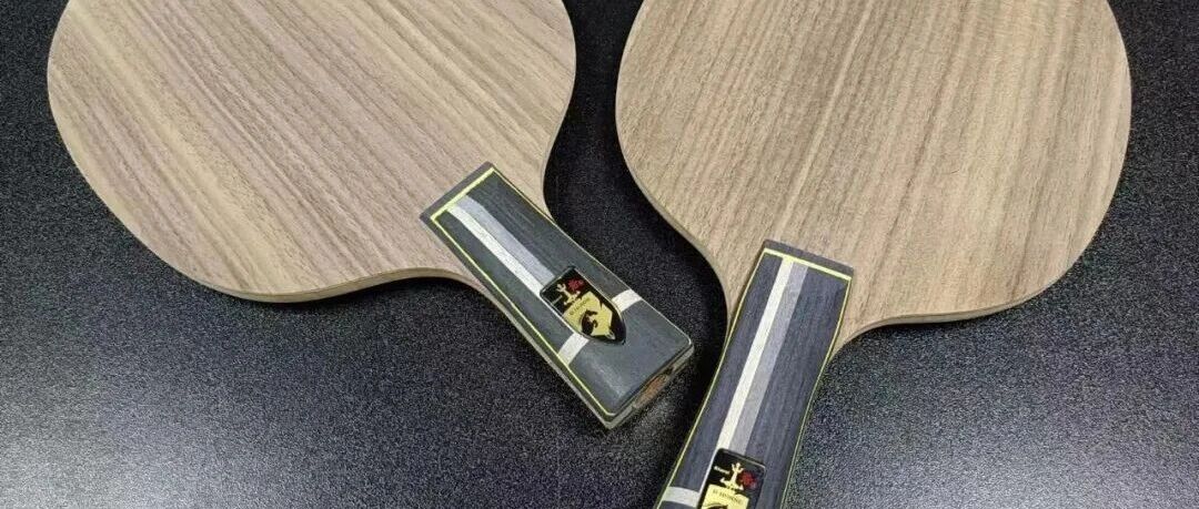 Two Tibhar walnut-surface table tennis blades laid side by side on a dark background