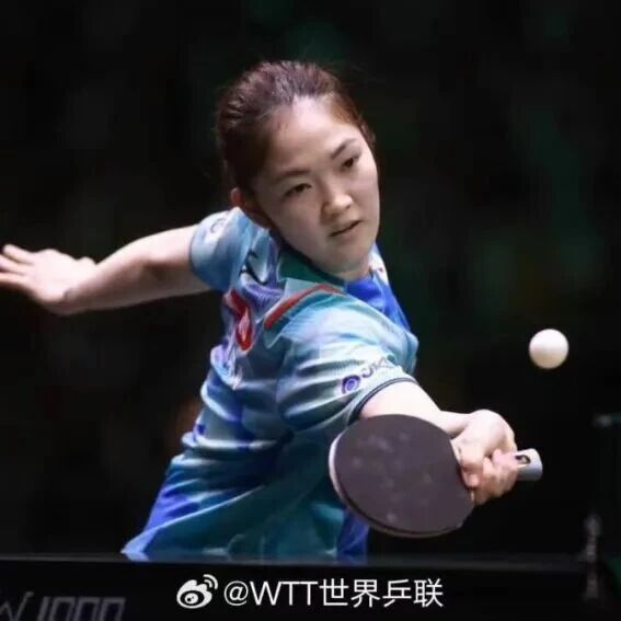 Female table tennis player in backhand drive action during a WTT event