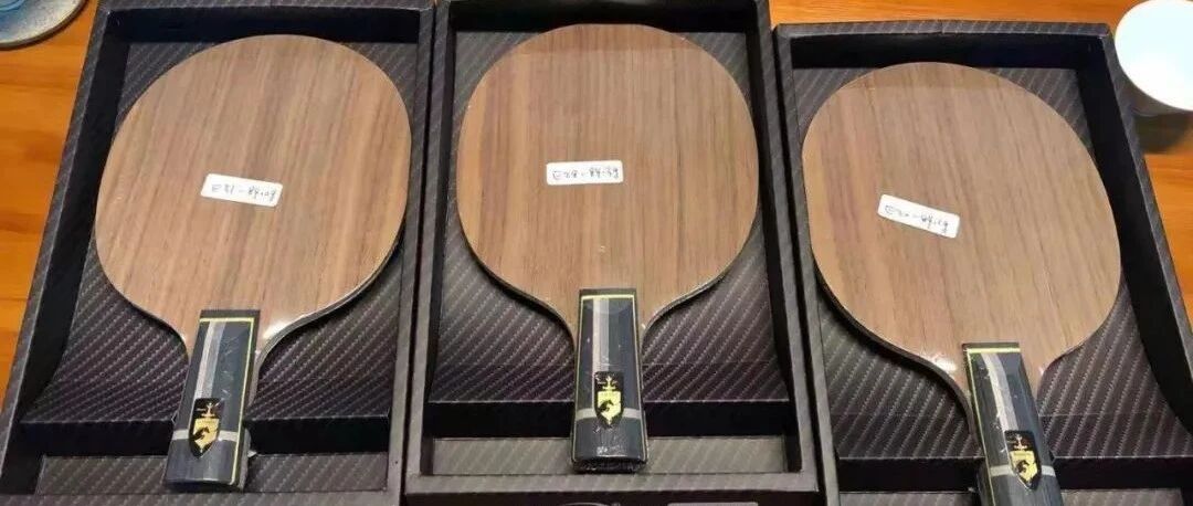 Three Galaxy handcrafted ALC table tennis blades laid out on a dark surface
