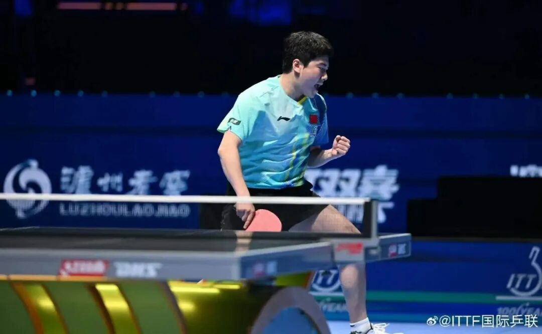 Liang Jingkun celebrating during a World Cup group stage match on a blue arena court