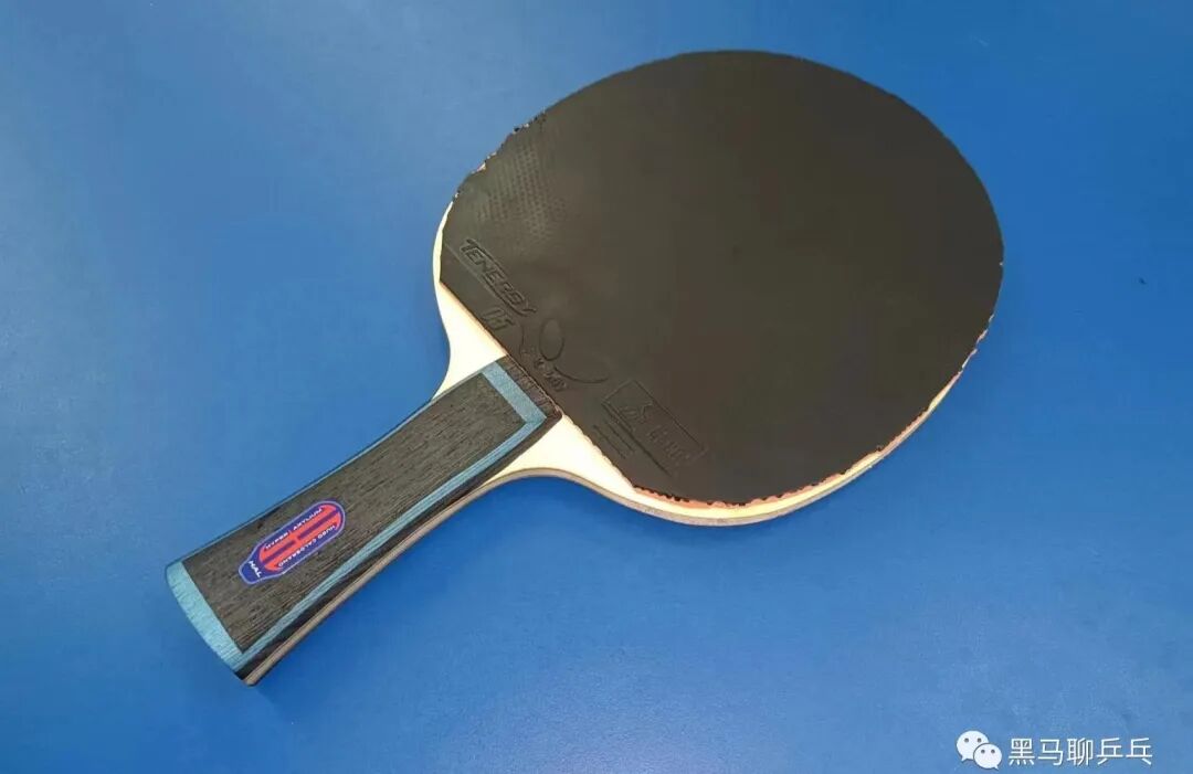 Worn table tennis rubber topsheet showing grip degradation on a carbon blade