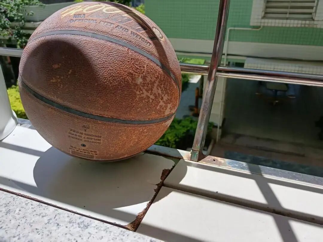 Basketball gathering dust in corner of apartment, untouched for ten years
