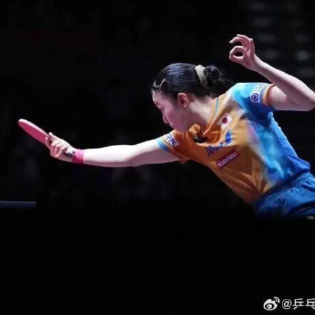 Female table tennis player in mid-stroke at a major competition