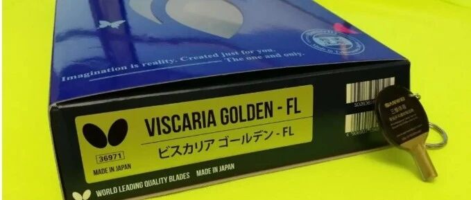 Butterfly Viscaria Golden FL blade in its box with a miniature commemorative paddle keychain