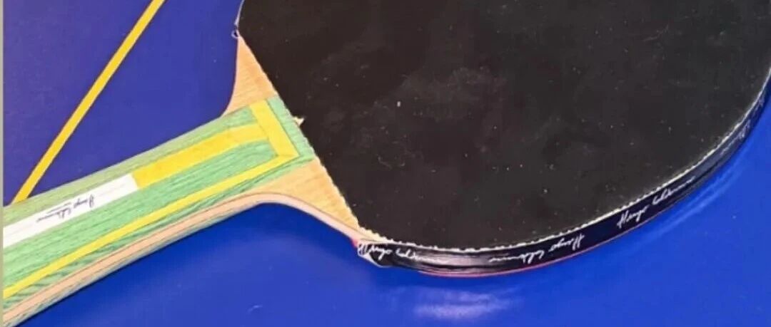 Hugo Calderano's custom inner-carbon blade prototype on a table tennis table