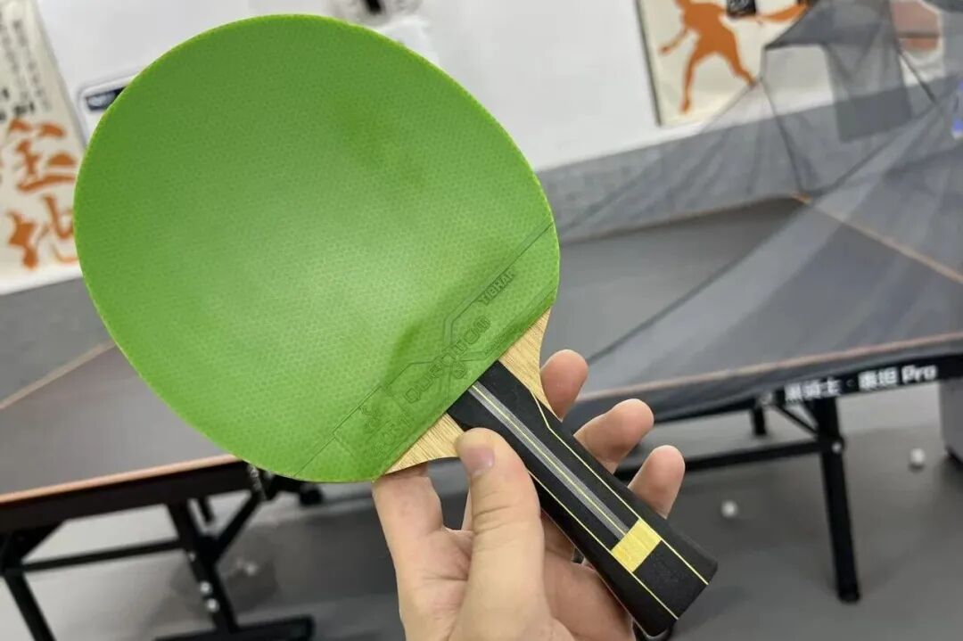 Forehand loop test showing ball arc trajectory with R-Code blade on table tennis table