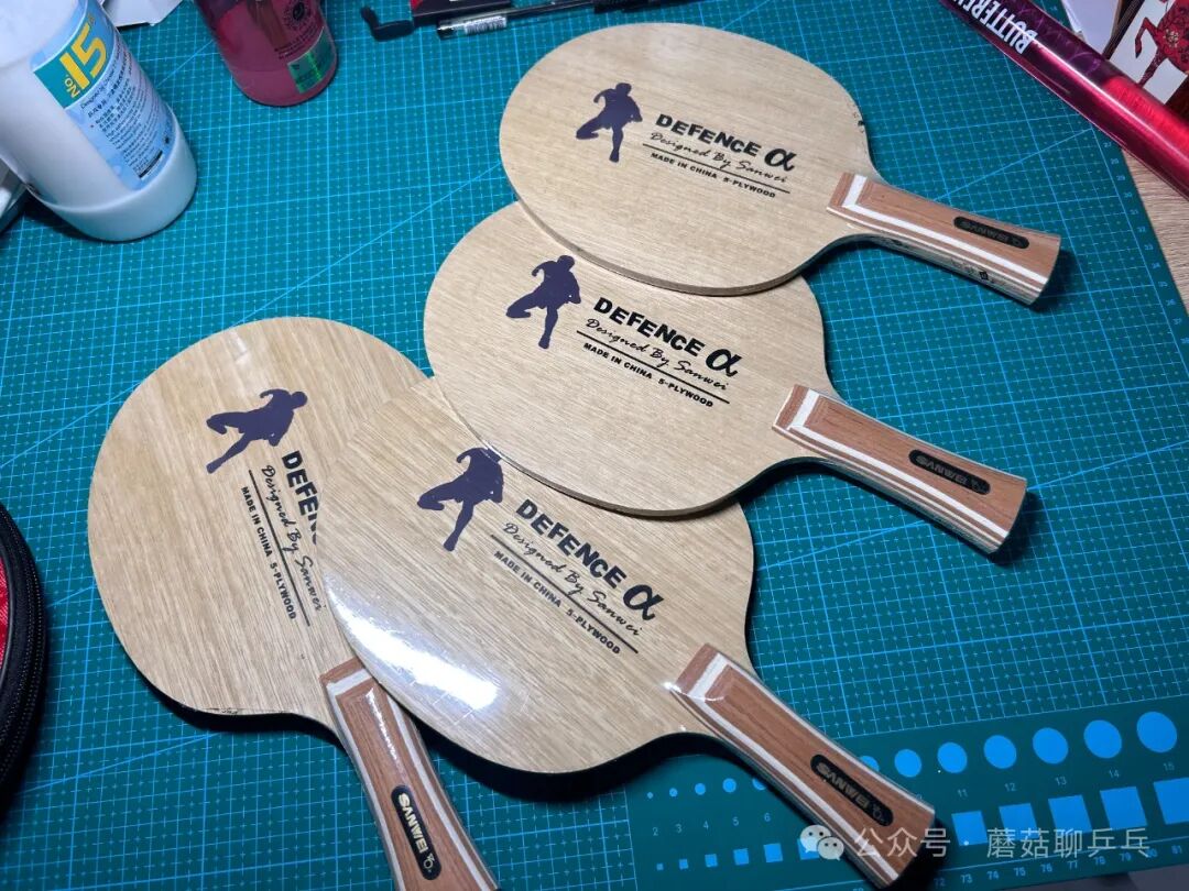 Multiple Sanwei Defence Alpha all-wood chopper blades laid out on a cutting mat