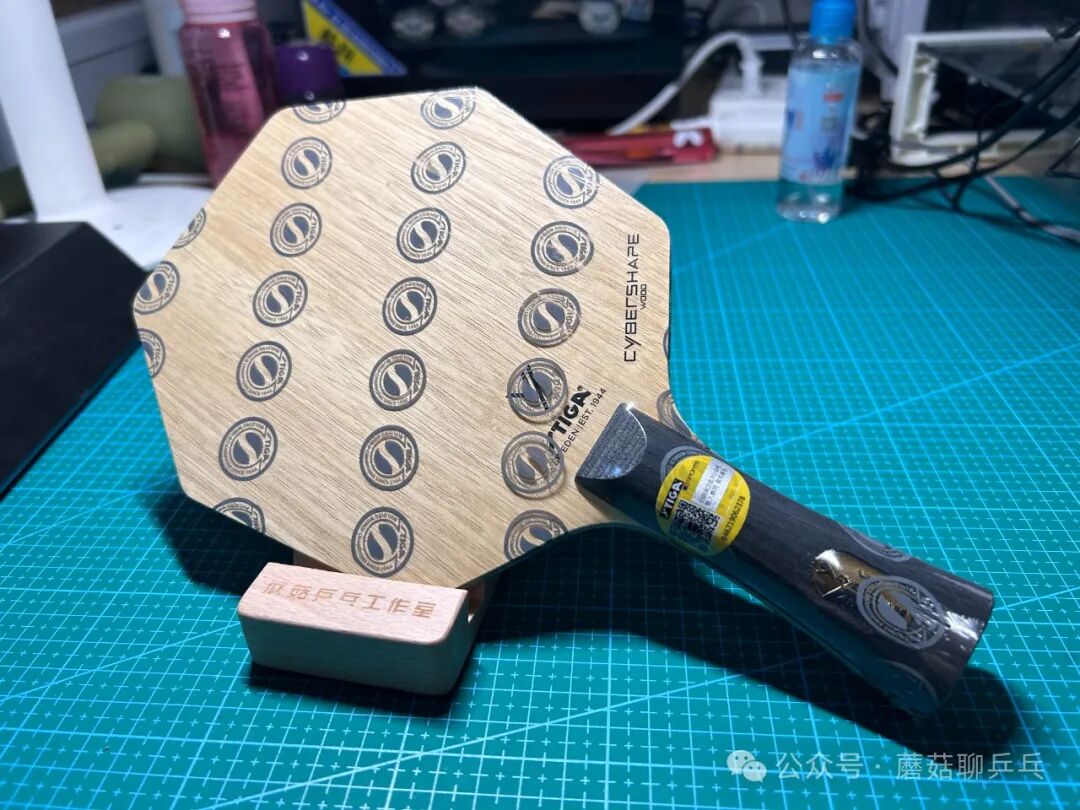 STIGA Cybershape Wood hexagonal blade with rubbers applied on a cutting mat