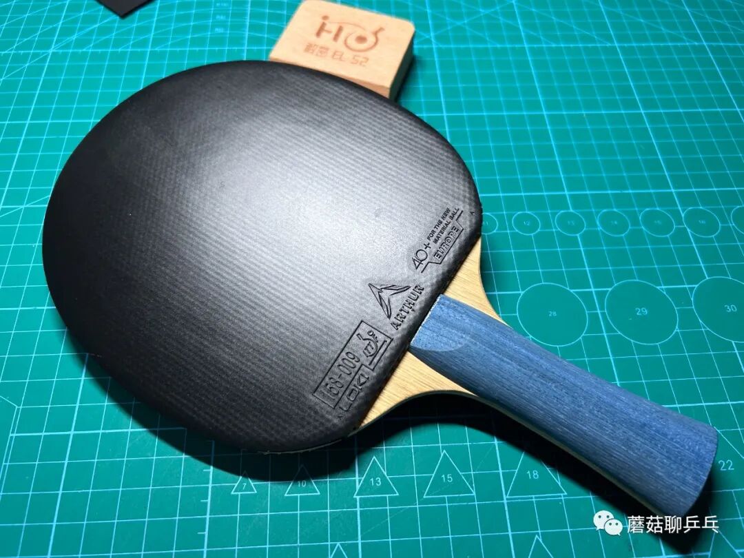 Loki Arthur Europe Diamond rubber mounted on a blue-handled blade, showing the black rubber sheet on a cutting mat