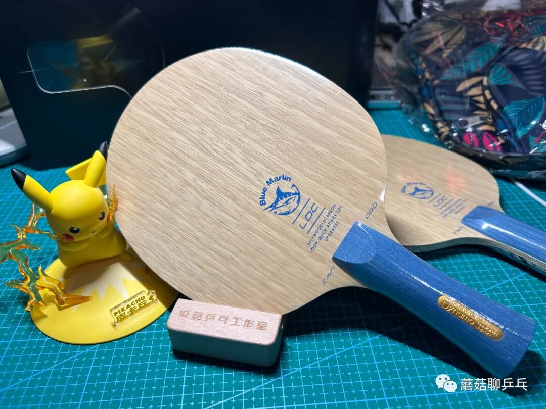 Sanwei Blue Marlin Pro carbon blade with blue handle alongside Pikachu figurine