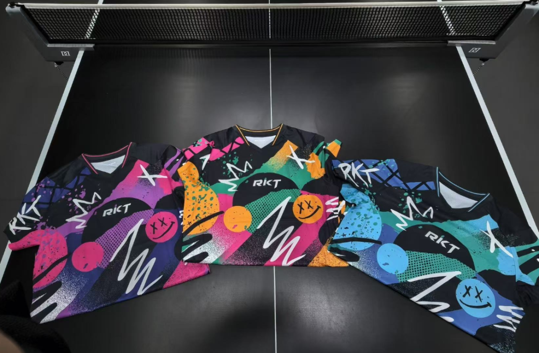 RKT Hyper-Power sports shirts in multiple colorful designs laid out on a table tennis table