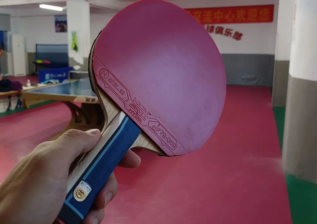 Table tennis player executing deliberate defensive return during training drill