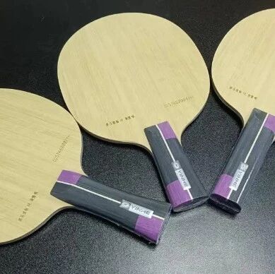 Three Yinhe special-edition blades with purple handles displayed on a dark surface