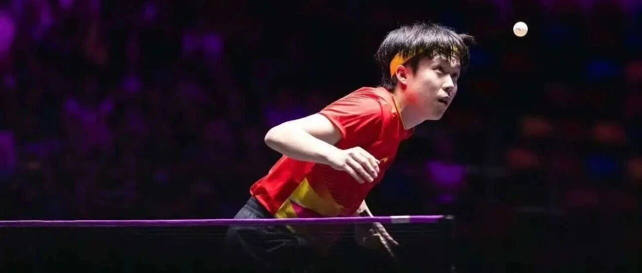 Fan Zhendong in action during a match under bright stage lighting