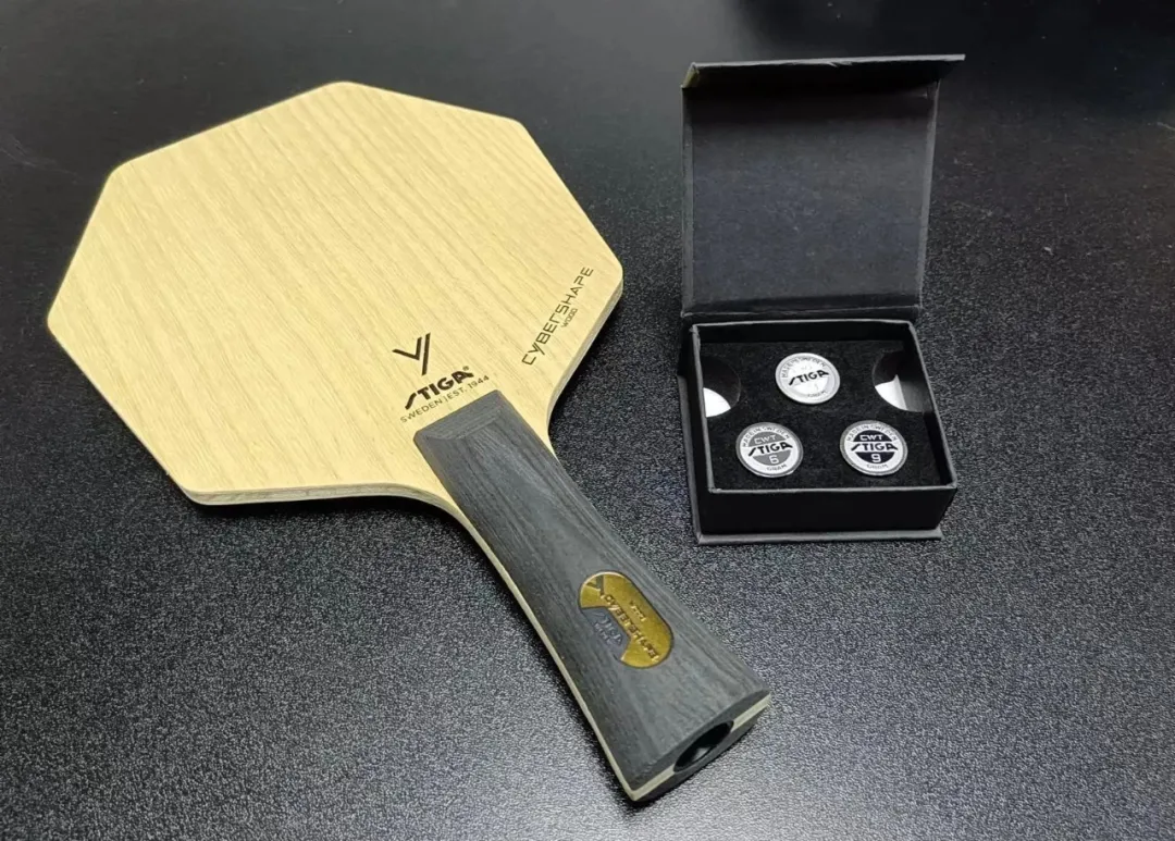 Stiga Cyber 6 blade with CWT weight kit in black box on a dark surface