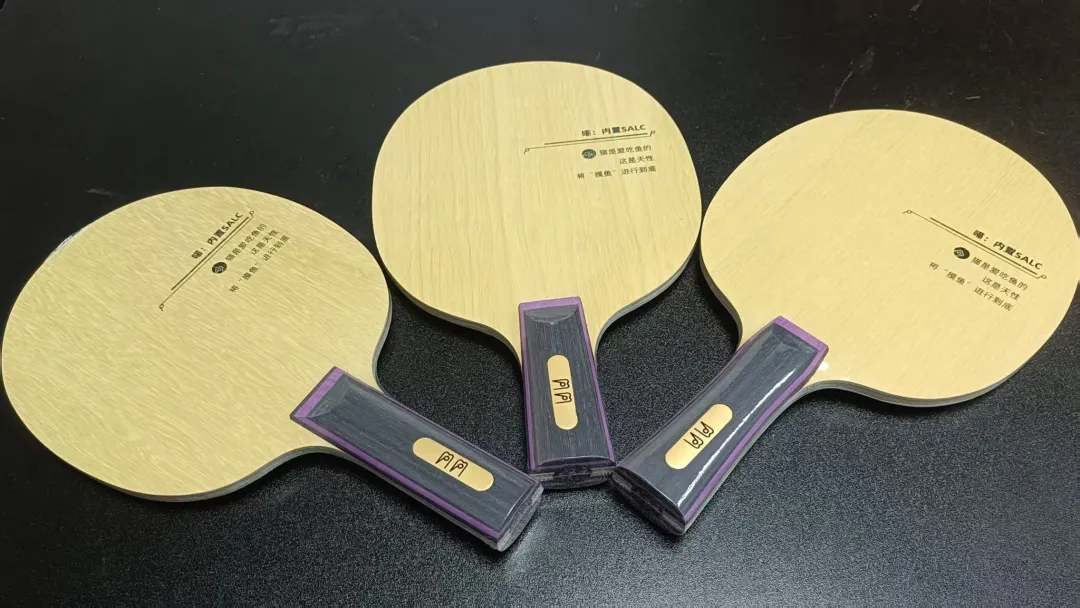 Close-up of a table tennis blade edge showing layered inner carbon construction with Stiga branding