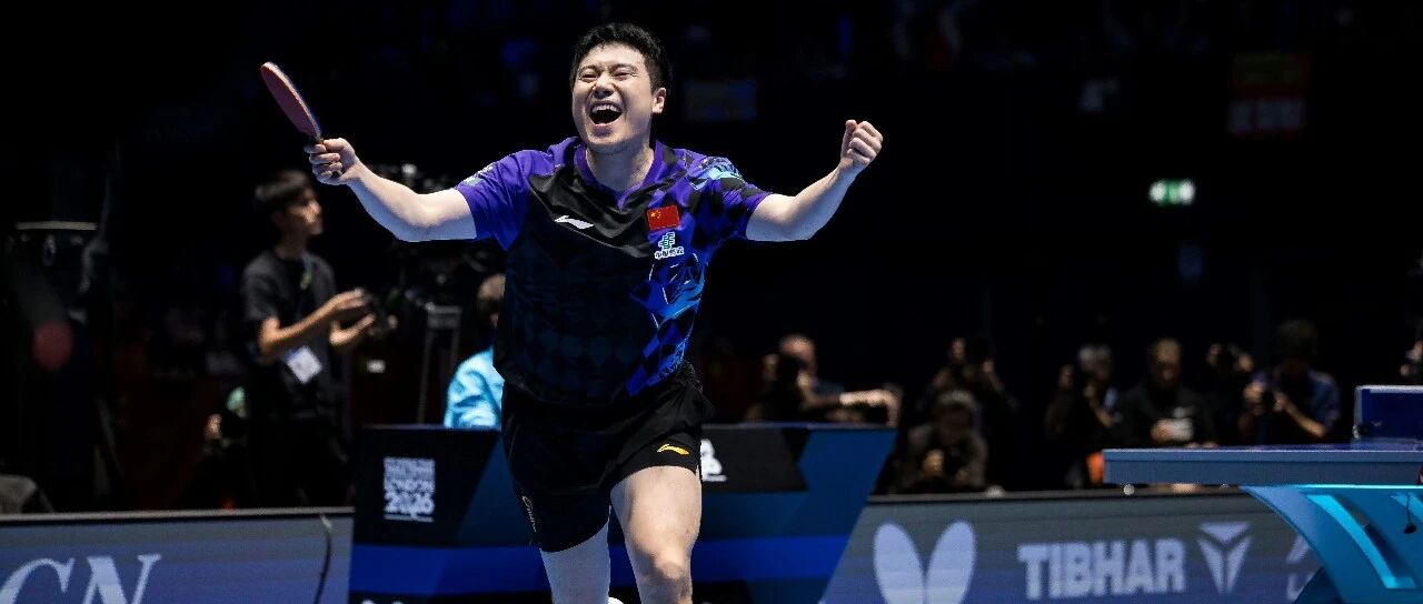 Liang Jingkun celebrates with arms outstretched at the World Team Championships in London