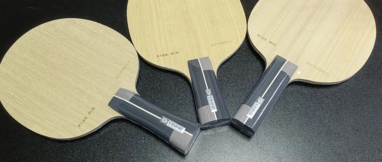 Three Heima custom PLC blades from Yinhe Blue Gold Workshop laid out on a black surface