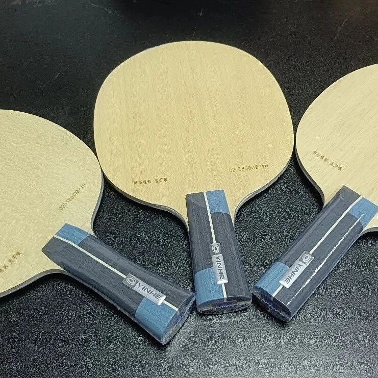 Three Heima custom ALC blades arranged on a black surface, showing the wood grain and Yinhe handles