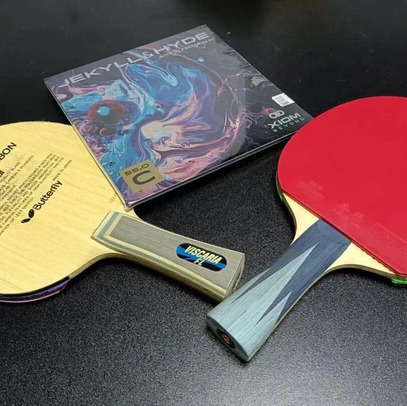 Table tennis paddles and rubber laid out showing equipment weight comparison