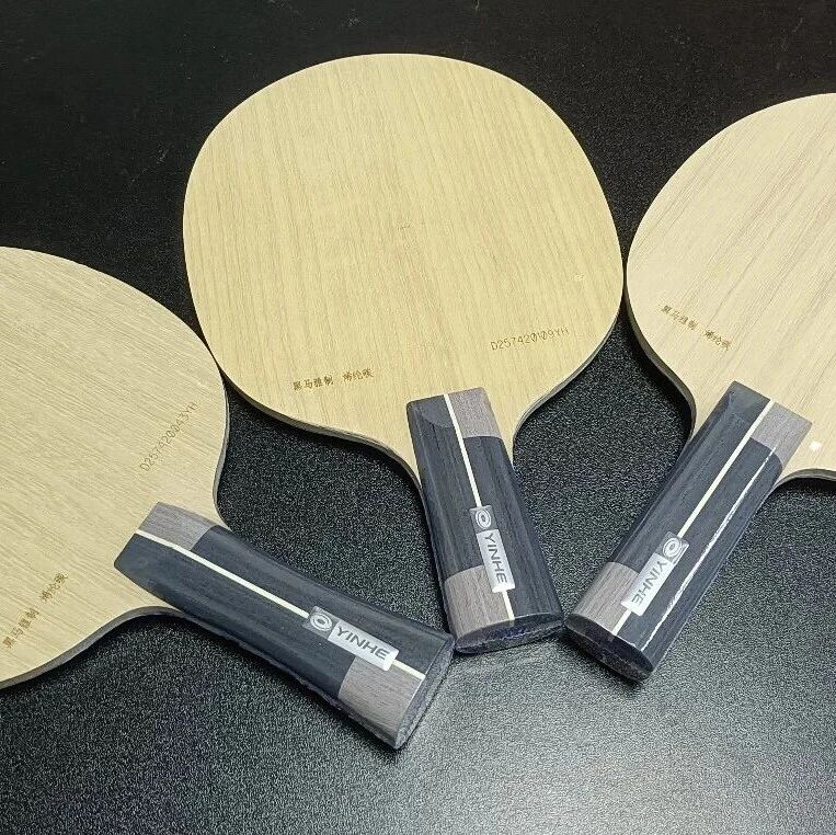 Multiple table tennis blades laid out for comparison